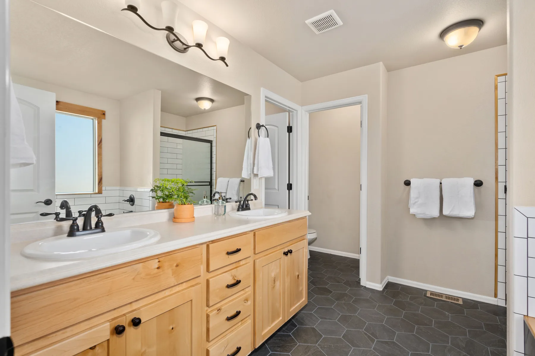 Representative modern bathroom with stone and wood finishes