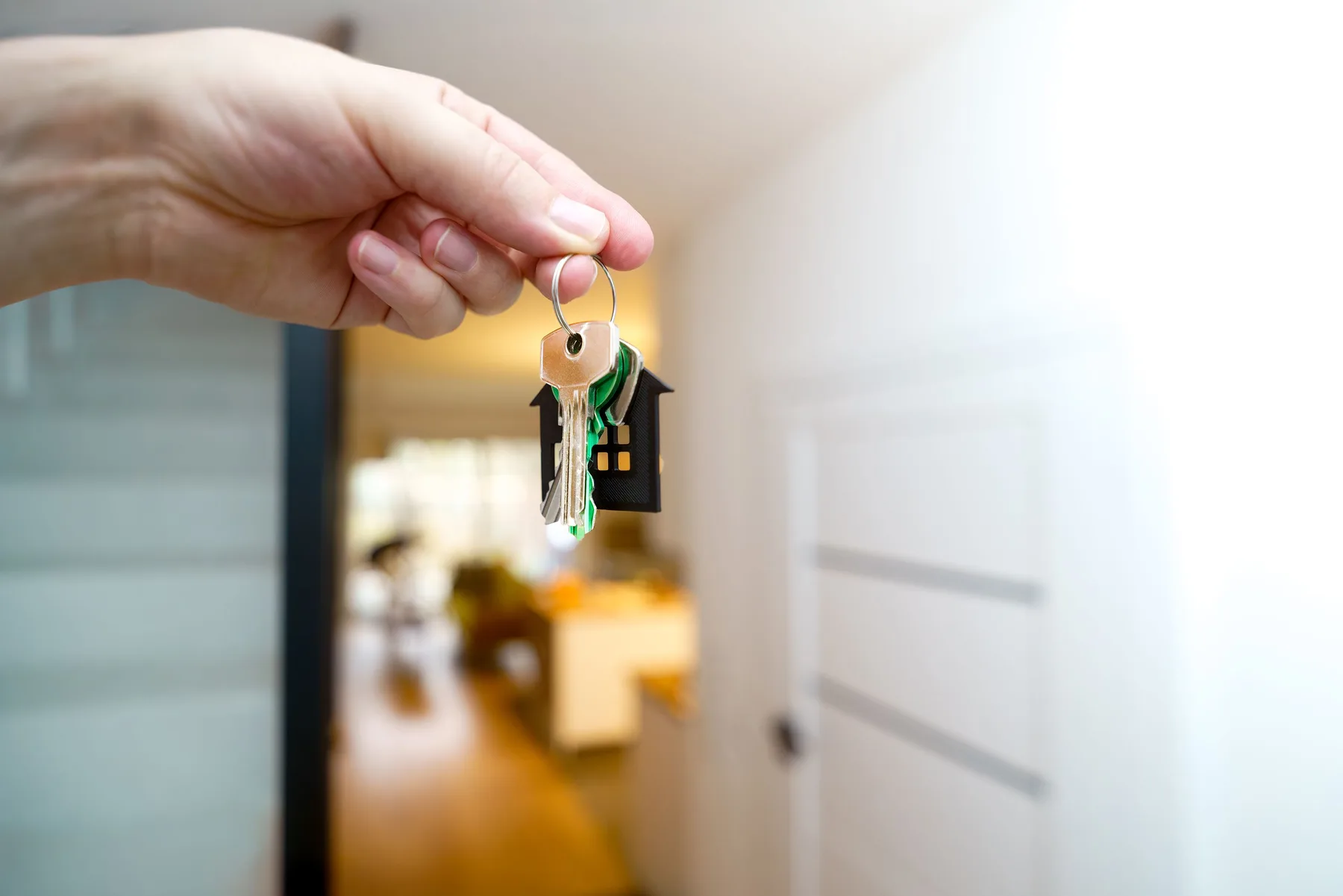 Representative photograph of a house key handover during a property discussion